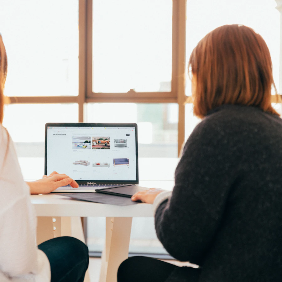 Two colleagues working together at a laptop